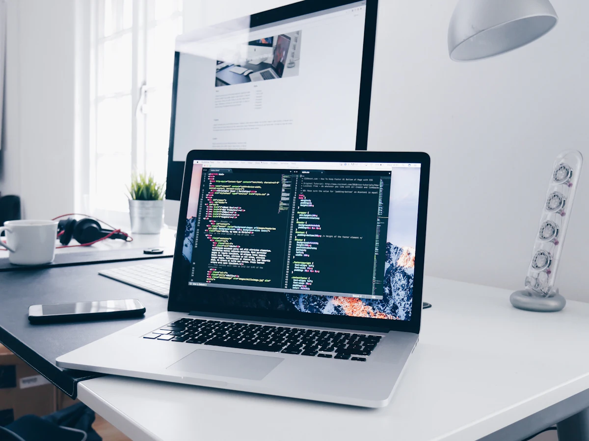 Laptop with code on screen on a bright, minimal desk