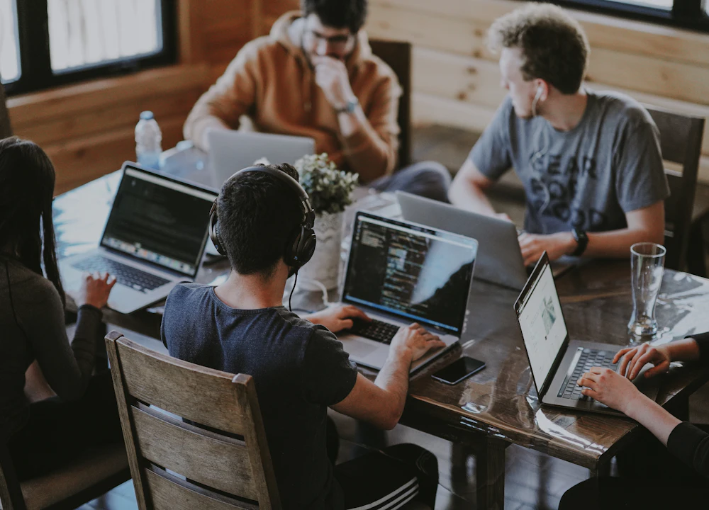 Team of people working together on laptops